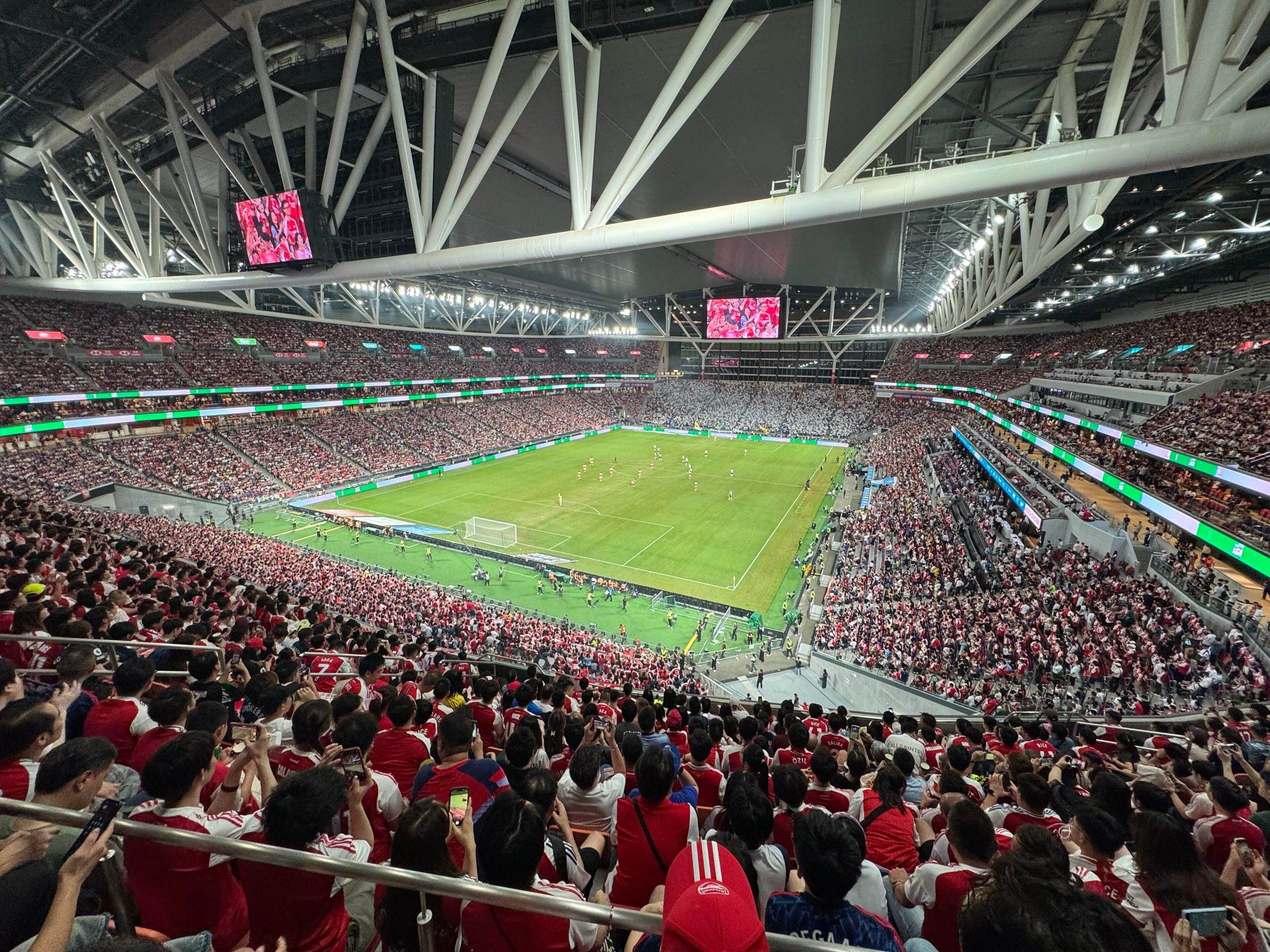 Kai Tak Stadium from the upper stands during a full-house match, under its steel roof