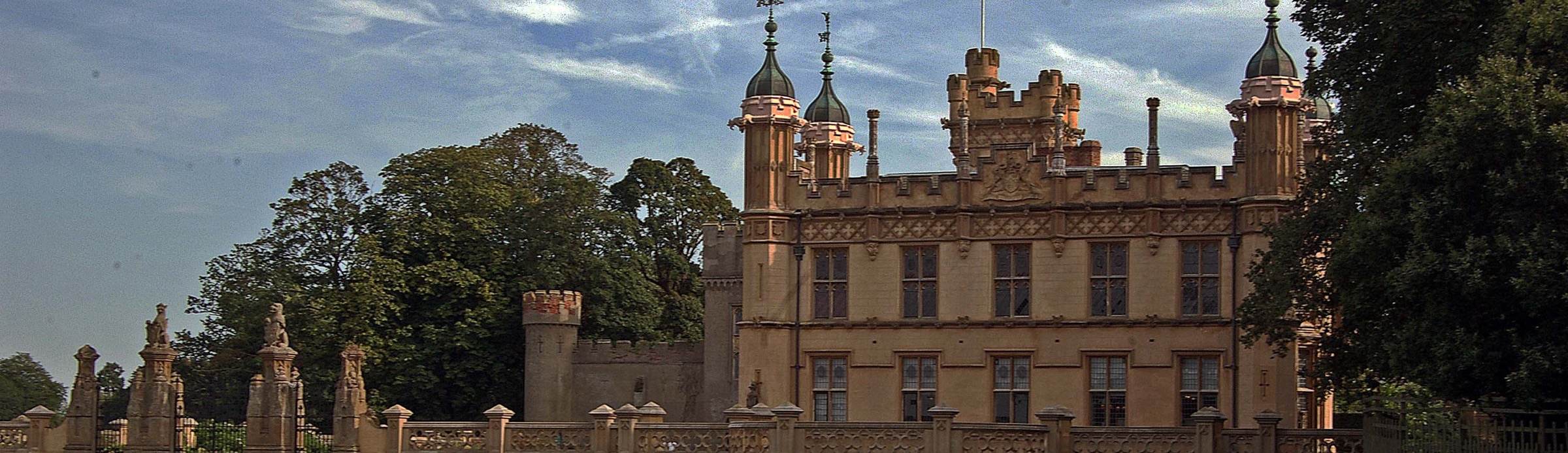 Knebworth House, its turrets and battlements above the lawn of the park