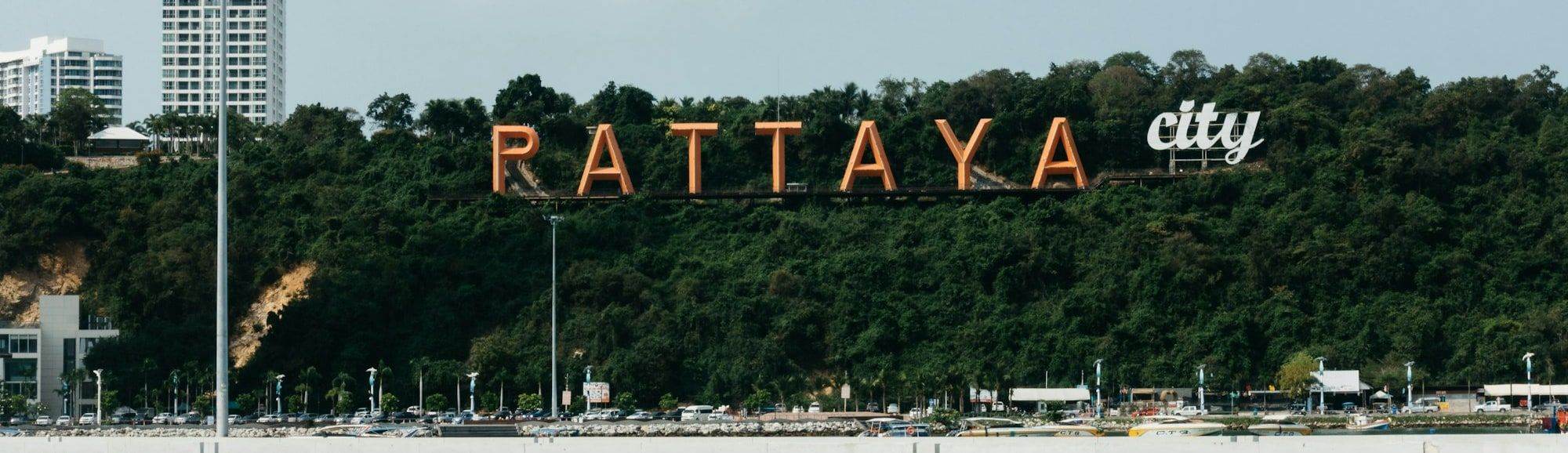 The Pattaya City sign on the hillside above the bay