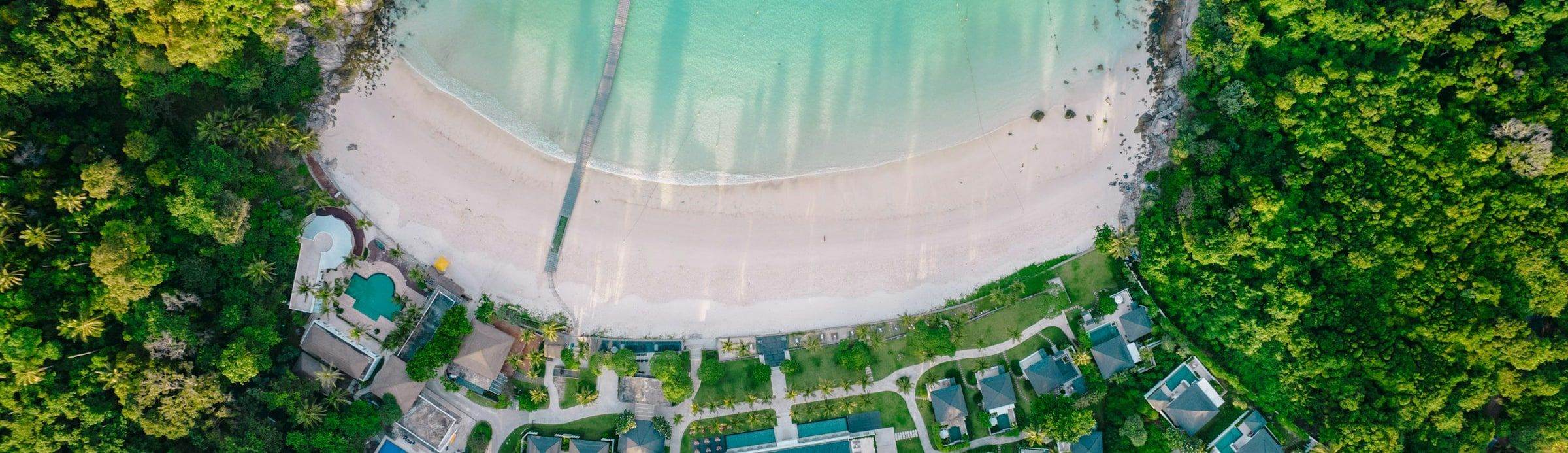 A Phuket beach and lagoon from the air, the Andaman coast beyond