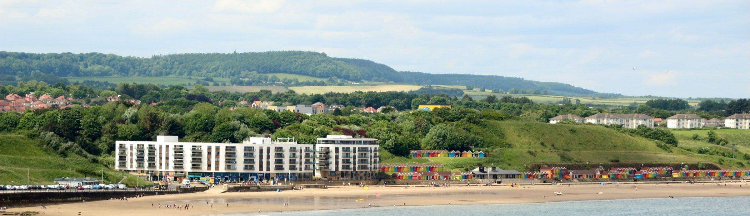 Scarborough's North Bay, the side of town the theatre is on: the beach, colourful beach huts and seafront apartments