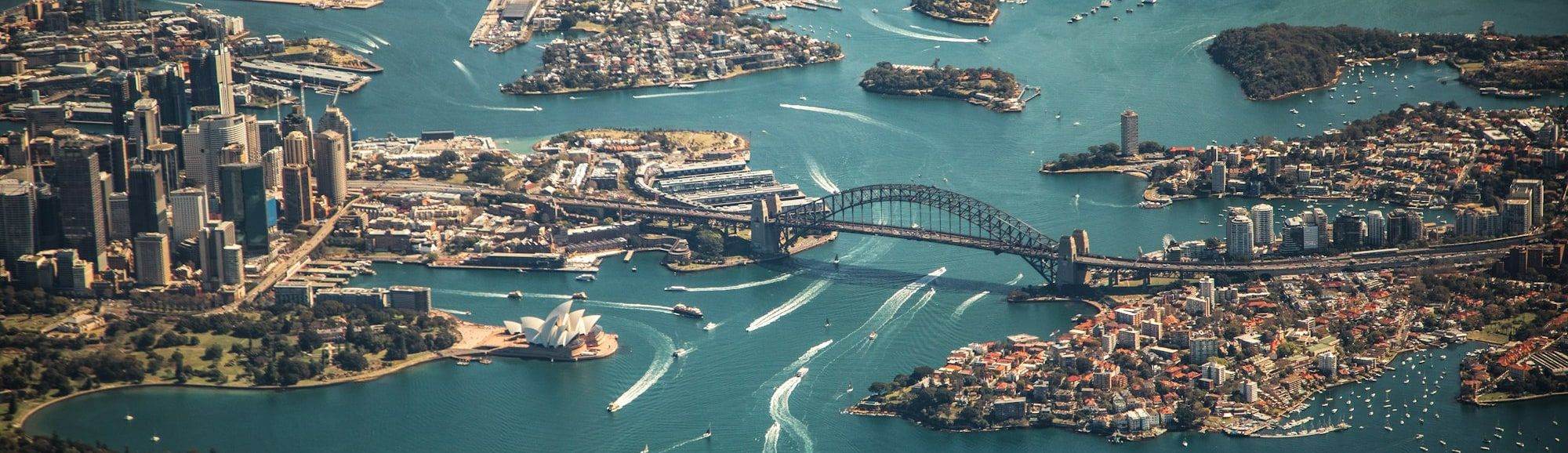 Sydney Harbour from the air, the bridge and opera house with the city behind